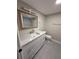 Modern bathroom featuring stylish vanity with marble countertop, framed mirror and updated fixtures at 1000 49Th N St # 309, St Petersburg, FL 33710
