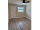 Cozy bedroom boasts new wood floors, a door to the exterior, large window, and neutral paint for easy decorating at 1000 49Th N St # 309, St Petersburg, FL 33710