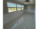 Bright bedroom featuring a large window, paneled wainscoting, tile floors, and a ceiling fan at 1000 49Th N St # 309, St Petersburg, FL 33710