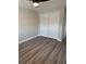 Cozy bedroom with wood flooring and ample storage with a sliding door closet at 1000 49Th N St # 309, St Petersburg, FL 33710