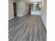 Inviting living space featuring wood floors and an open layout that connects to the modern kitchen and chandelier at 1000 49Th N St # 309, St Petersburg, FL 33710