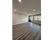 A modern living space with wood floors, neutral wall color, lots of natural light, and updated baseboards at 1000 49Th N St # 309, St Petersburg, FL 33710