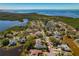 Neighborhood aerial view featuring lovely homes surrounded by lakes and the bay in the distance at 1006 Osprey Ct, Tarpon Springs, FL 34689