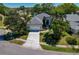 Charming home boasts mature landscaping and a driveway leading to a 2-car garage at 1006 Osprey Ct, Tarpon Springs, FL 34689