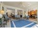 Bright sunroom with tile floors, ceiling fan, and views into the living room and dining room at 1006 Osprey Ct, Tarpon Springs, FL 34689