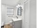 Bathroom featuring a modern vanity, sleek mirror, and tile backsplash at 1008 E Norfolk St, Tampa, FL 33604