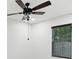 Bedroom featuring a ceiling fan with light, one window with blinds, and white walls at 1008 E Norfolk St, Tampa, FL 33604
