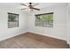 Bright bedroom with wood-look floors, ceiling fan, and natural light from two windows at 1008 E Norfolk St, Tampa, FL 33604