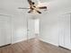 Bedroom featuring wood-look floors, white trim, and convenient double closet space at 1008 E Norfolk St, Tampa, FL 33604