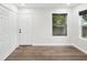 Empty bedroom featuring a closet, a window with blinds, and hard wood floors at 1008 E Norfolk St, Tampa, FL 33604