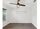 Clean bedroom with a ceiling fan and natural light from a window with blinds at 1008 E Norfolk St, Tampa, FL 33604