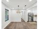 Bright dining area with stainless steel appliances, stylish lighting, and hardwood floors at 1008 E Norfolk St, Tampa, FL 33604