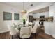 Open-concept dining area with kitchen view, featuring a modern glass table at 1008 E Norfolk St, Tampa, FL 33604