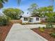 Beautiful curb appeal of this home, featuring a long driveway, fresh landscaping, and a cozy front entrance at 1008 E Norfolk St, Tampa, FL 33604