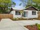 Cozy home featuring a metal roof, nicely landscaped yard, and a concrete driveway at 1008 E Norfolk St, Tampa, FL 33604