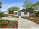 Charming single story home with a manicured lawn and a long driveway leading up to the front entrance at 1008 E Norfolk St, Tampa, FL 33604