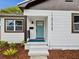 Inviting front porch with a stylish blue door, freshly painted steps, and modern address numbers at 1008 E Norfolk St, Tampa, FL 33604