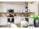 Modern kitchen with white cabinets, stainless steel appliances, and updated backsplash at 1008 E Norfolk St, Tampa, FL 33604