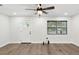 Bright living room with modern ceiling fan, wood-look floors, and lots of natural light at 1008 E Norfolk St, Tampa, FL 33604