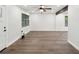 Open-concept living area with modern ceiling fan, wood-look floors, and natural light from windows at 1008 E Norfolk St, Tampa, FL 33604