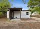 An inviting backyard patio with brickwork, a covered overhang, and vinyl siding on the home's exterior at 1008 E Norfolk St, Tampa, FL 33604