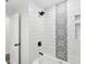 Modern shower with black fixtures and decorative tile, offering a luxurious bathing experience at 1008 E Norfolk St, Tampa, FL 33604