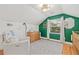 Bright bedroom featuring a dresser and a comfortable chair, illuminated by a stylish light fixture at 1010 26Th N Ave, St Petersburg, FL 33704