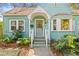 Inviting light blue bungalow featuring a lovely entrance and well-maintained landscaping at 1010 26Th N Ave, St Petersburg, FL 33704