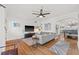 Bright living room with hardwood floors, a gray sofa, and an open layout to the dining area at 1010 26Th N Ave, St Petersburg, FL 33704