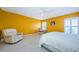 Bright bedroom features hard floors, fan, white ceiling and sunny yellow walls at 1032 Blyth Hill Ct, Trinity, FL 34655