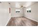 This is a spacious bedroom that has two windows, wood plank flooring, and a ceiling fan at 11050 Auburndale St, Spring Hill, FL 34609