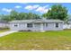 Charming home with a well-manicured lawn and neatly arranged garden beds at 11050 Auburndale St, Spring Hill, FL 34609