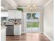 Eat-in kitchen featuring plank flooring, stainless steel dishwasher, and sliding doors to the patio at 11050 Auburndale St, Spring Hill, FL 34609