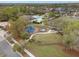 Aerial view showcasing the community park featuring a playground, green space, and shaded picnic area at 11218 Coventry Grove Cir, Lithia, FL 33547