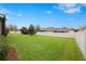 Spacious backyard with a well-maintained lawn, mature trees, and a privacy fence, perfect for outdoor activities at 11218 Coventry Grove Cir, Lithia, FL 33547