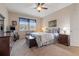 Bedroom featuring light walls, carpet, ceiling fan, a dresser and queen size bed at 11218 Coventry Grove Cir, Lithia, FL 33547