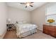 Cozy bedroom featuring a comfortable bed, neutral decor, and a window providing natural light at 11218 Coventry Grove Cir, Lithia, FL 33547