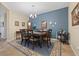 Dining room boasting a decorative light fixture, dark wood table and blue accent wall at 11218 Coventry Grove Cir, Lithia, FL 33547