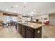 Kitchen with stainless appliances, large island, barstool seating and adjacent living area at 11218 Coventry Grove Cir, Lithia, FL 33547