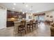 A open concept kitchen with dark cabinetry, tile floors, bar seating and a granite-topped island at 11218 Coventry Grove Cir, Lithia, FL 33547