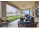 Relaxing screened-in patio with wicker furniture and a serene outdoor view at 11218 Coventry Grove Cir, Lithia, FL 33547