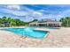 Community pool with palm trees, lounge area, and clubhouse in the background at 11218 Coventry Grove Cir, Lithia, FL 33547