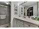 Bright bathroom with a walk-in shower, ample counter space, and closet access at 12041 Hoosier Ct # 104, Hudson, FL 34667