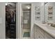 Well-organized bathroom featuring a walk-in shower, vanity with storage, and a closet at 12041 Hoosier Ct # 104, Hudson, FL 34667