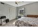 Cozy bedroom with a floral comforter, window and closet at 12041 Hoosier Ct # 104, Hudson, FL 34667
