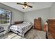 Traditional bedroom with warm wood furniture, neutral walls, and cozy carpet flooring at 12041 Hoosier Ct # 104, Hudson, FL 34667