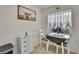 Cozy breakfast nook with a round table, white storage cabinet, and a sunny window view at 12041 Hoosier Ct # 104, Hudson, FL 34667
