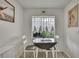 Bright breakfast nook with natural light, adorned with charming curtains and wall art at 12041 Hoosier Ct # 104, Hudson, FL 34667