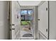 Warm welcome: Bright entryway view showcasing outdoor landscaping and nearby building at 12041 Hoosier Ct # 104, Hudson, FL 34667