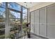 Screened lanai with views of the yard and storage space at 12041 Hoosier Ct # 104, Hudson, FL 34667